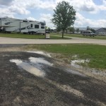 
              Puddles are shown in the campground at Eldora Speedway in Rossburg, Ohio, Monday, July 20, 2015.  Persistent rains and the tightest turnaround in the history of the track has the Eldora Speedway staff in an all-out grind before Wednesday night's, July 22,  Truck Series race, one of the marquee events on the NASCAR schedule. (AP Photo/Jenna Fryer
            