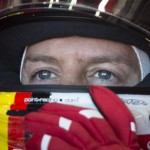 
              Ferrari driver Sebastian Vettel of Germany adjusts his helmet as he waits to hit the track during the third practice session at the F1 Canadian Grand Prix auto race in Montreal on Saturday, June 6, 2015.  (Paul Chiasson/The Canadian Press via AP) MANDATORY CREDIT
            