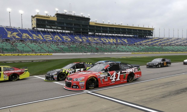 Competitors, including Kurt Busch (41), pull onto pit row during qualifying for Saturday’s Sp...