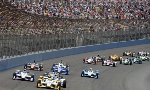 Simon Pagenaud (22), from France, leads the field toward Turn 1 on Saturday June 27, 2015, on the o...