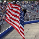 
              A United States flag, carried by a sky diver, arrives at the start/finish line at the IndyCar Series race at the Milwaukee Mile in West Allis, Wis., Sunday, July 12, 2015. (AP Photo/Jeffrey Phelps)
            