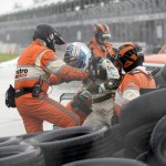
              Luca Fillippi of Italy is helped out of his car after running into the tire barrier on the first turn during the first race of the IndyCar Detroit Grand Prix auto racing doubleheader Saturday, May 30, 2015, in Detroit. Carlos Munoz won his first career IndyCar victory when the race was called because of rain after 47 laps. (AP Photo/Carlos Osorio)
            