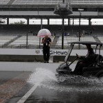 
              A cart splashes up water as its crosses the start/finish line as rain closed the track on the first day of qualifications for the Indianapolis 500 auto race at Indianapolis Motor Speedway in Indianapolis, Saturday, May 16, 2015.  (AP Photo/Darron Cummings)
            