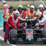 
              Track marshals help McLaren Honda driver Fernando Alonso of Spain to push his car after it broke down during the qualification for the Hungarian Formula One Grand Prix in Budapest, Hungary, Saturday, July 25, 2015. The Hungarian Formula One Grand Prix will be held on Sunday July, 26. (AP Photo/Ronald Zak, Pool)
            