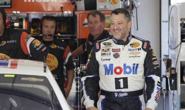 Tony Stewart walks to his car during practice for the NASCAR Sprint Cup Series auto race Friday, Ju...