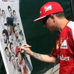 
              Ferrari driver Kimi Raikkonen, of Finland, signs a painting of drivers at the F1 Canadian Grand Prix auto race, Thursday, June 4, 2015, in Montreal. (Tom Boland/The Canadian Press via AP)
            