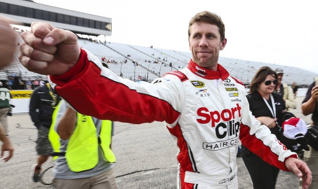 Carl Edwards fist-bumps after winning the pole position qualifying for Sunday’s NASCAR Sprint...