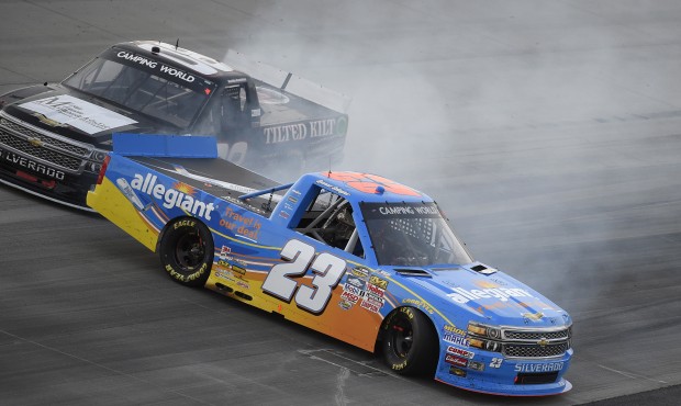 Spencer Gallagher (23) gets sideways next to Korbin Forrister, top, during a NASCAR Trucks series a...
