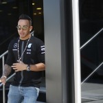 
              Mercedes driver Lewis Hamilton of Britain leaves the Mercedes motorhome at the Monaco racetrack, in Monaco, Wednesday, May 20, 2015. Formula One champion Lewis Hamilton signed a new 3-year deal with Mercedes on Wednesday, ending rumors of his potential move to Ferrari. The deal was announced ahead of this weekend's Monaco Grand Prix.The Formula one race will be held on Sunday. (AP Photo/Luca Bruno)
            
