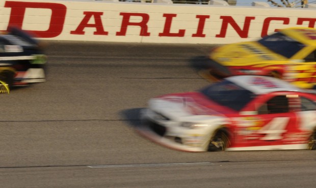 FILE – In this April 12, 2014, file photo, Kevin Harvick (4) and Joey Logano (22) race during...
