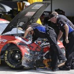 
              Crew members for Greg Biffle repair damage to his car after he was involved in a wreck during a NASCAR Sprint Cup practice session at Daytona International Speedway, Friday, July 3, 2015, in Daytona Beach, Fla. (AP Photo/John Raoux)
            