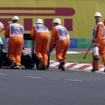 
              Track marshals help McLaren Honda driver Fernando Alonso of Spain to push his car after it broke down during the qualification for the Hungarian Formula One Grand Prix in Budapest, Hungary, Saturday, July 25, 2015. The Hungarian Formula One Grand Prix will be held on Sunday July, 26. (AP Photo/Petr David Josek)
            