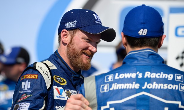 Dale Earnhardt Jr., left, talks to Jimmie Johnson, right, in Victory Lane after winning the Tallade...