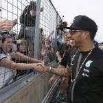
              Mercedes driver Lewis Hamilton, of Great Britain, shakes hands with fans after winning the Canadian Grand Prix Sunday, June 7, 2015, in Montreal. (Graham Hughes/The Canadian Press via AP) MANDATORY CREDIT
            