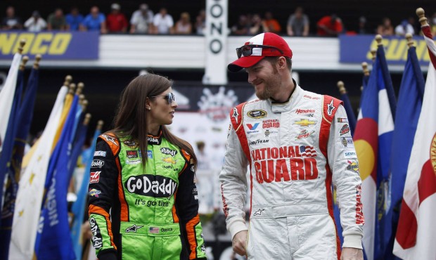 FILE – In this Aug. 3, 2014 file photo, Dale Earnhardt Jr., right, and Danica Patrick talk du...