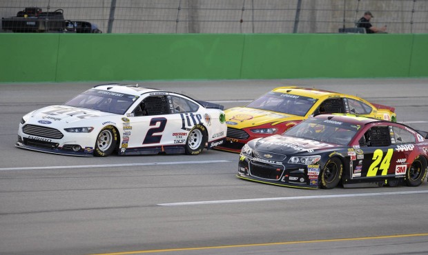 Brad Keselowski (2), Jeff Gordon (24), and Joey Logano drive at the front of the field in the early...