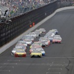 
              Sprint Cup Series drivers Carl Edwards (19) and Joey Logano (22) lead the field on the start of the NASCAR Brickyard 400 auto race at Indianapolis Motor Speedway in Indianapolis, Sunday, July 26, 2015.  (AP Photo/Darron Cummings)
            