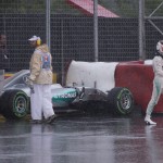 
              Mercedes driver Lewis Hamilton, of Great Britain, walks away from his car after crashing into the safety barrier at the hairpin as heavy rain falls during the second practice session, Friday, June 5, 2015, for the F1 Canadian Grand Prix auto race in Montreal. (Jacques Boissinot/The Canadian Press via AP) MANDATORY CREDIT
            