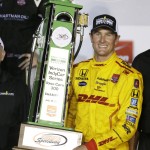 
              Ryan Hunter-Reay holds the trophy in Victory Lane after winning the IndyCar Series auto race Saturday, July 18, 2015, at Iowa Speedway in Newton, Iowa. (AP Photo/Charlie Neibergall)
            