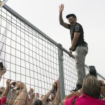 
              Mercedes driver Lewis Hamilton, of Great Britain, climbs the catch fence to wave to fans after winning the Canadian Grand Prix Sunday, June 7, 2015, in Montreal. (Graham Hughes/The Canadian Press via AP) MANDATORY CREDIT
            