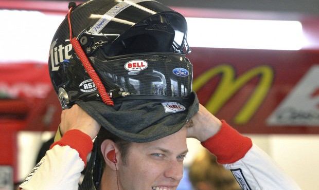 Brad Keselowski puts on his helmet in anticipation of the end of the rain delay of practice for the...