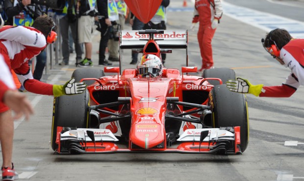 Ferrari driver Sebastian Vettel of Germany arrives for a pit service during the second training ses...