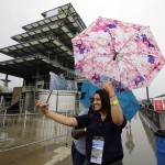 
              Fans take a photo in front of the Pagoda as rain closed the track on the first day of qualifications for the Indianapolis 500 auto race at Indianapolis Motor Speedway in Indianapolis, Saturday, May 16, 2015.  (AP Photo/Darron Cummings)
            