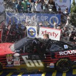 
              Chris Buescher is doused as he climbs out of his car in Victory Lane after winning the NASCAR Xfinity series auto race, Saturday, May 30, 2015, at Dover International Speedway in Dover, Del. (AP Photo/Nick Wass)
            