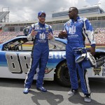 
              Dale Earnhardt Jr., left, talks with Carolina Panthers linebacker Thomas Davis, right, during a news conference at Charlotte Motor Speedway in Concord, N.C., Tuesday, May 19, 2015. Davis, the NFL's Man of the Year, has been selected to be the honorary pace car driver for the Coca Cola 600 on Sunday. Dale Earnhardt Jr took Davis on several high speed laps around the track. (AP Photo/Chuck Burton)
            