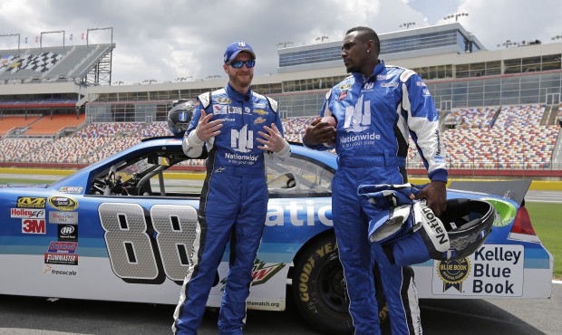 Dale Earnhardt Jr., left, talks with Carolina Panthers linebacker Thomas Davis, right, during a new...