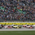 
              NASCAR driver Joey Logano (22) leads the field into the first lap of a Sprint Cup Series auto race at Kansas Speedway in Kansas City, Kan., Saturday, May 9, 2015. (AP Photo/Orlin Wagner)
            