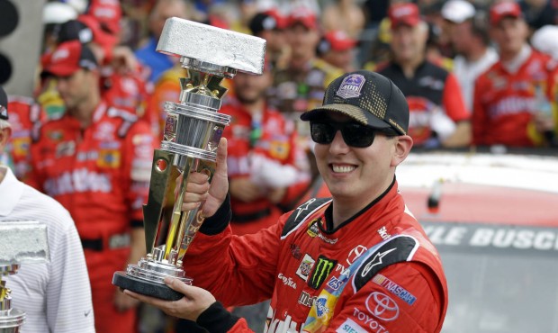 Kyle Busch celebrates after winning the NASCAR Brickyard 400 auto race at Indianapolis Motor Speedw...