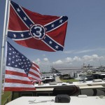
              Confederate and American flags fly on top of a motor home at Daytona International Speedway, Saturday, July 4, 2015, in Daytona Beach, Fla. NASCAR and the speedway offered to replace any flag a race brings to the track with an American flag. (AP Photo/Phelan M. Ebenhack)
            
