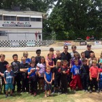 
              In this photo taken Saturday, June 20, 2015, NASCAR driver Jeff Gordon, rear third from right, poses with all the racers participating in the quarter-midget events at Roy Hayer Memorial Speedway in Rio Linda, Calif. Gordon began his career at the quarter-midget dirt track when he was 5 and the track was called Cracker Jack Track. (AP Photo/Jenna Fryer)
            