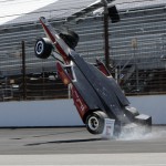 
              The car driven by Helio Castroneves, of Brazil, flips after hitting the wall in the first turn during practice for the Indianapolis 500 auto race at Indianapolis Motor Speedway in Indianapolis, Wednesday, May 13, 2015.  (AP Photo/Joe Watts)
            