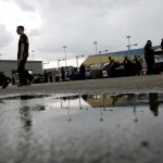 
              Rain falls as car line up for inspections before qualifying for the NASCAR Xfinity Series auto race at the Iowa Speedway, Saturday, May 16, 2015, in Newton, Iowa. (AP Photo/Justin Hayworth)
            