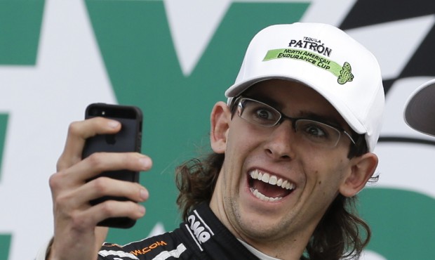 FILE – In this Jan. 26, 2014, file phot, Jordan Taylor takes a selfie in Victory Lane after f...