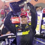 
              Carl Edwards raises the trophy in Victory Lane after winning the NASCAR Sprint Cup series auto race at Charlotte Motor Speedway in Concord, N.C., Sunday, May 24, 2015. (AP Photo/Terry Renna)
            