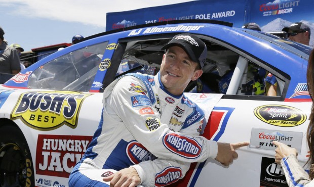A.J. Allmendinger poses by his car after winning the pole position qualifying for the NASCAR Sprint...