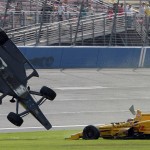 
              Ryan Briscoe flips through the infield grass next to Ryan Hunter-Reay on Saturday June 27, 2015 during the IndyCar auto race at Auto Club Speedway in Fontana, Calif. (AP Photo/Will Lester)
            