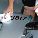 
              Mercedes technician cleans part of Germany's Nico Rosberg's car where a sign commemorating late French Formula One driver Jules Bianchi is placed during the free practice at the Hungarian Formula One Grand Prix in Budapest, Hungary, Saturday, July 25, 2015. Bianchi, 25, died Friday July, 17, from head injuries sustained in a crash at last year's Japanese Grand Prix. The Hungarian Formula One Grand Prix will be held on Sunday July, 26. (AP Photo/Ronald Zak)
            