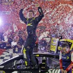 
              Carl Edwards celebrates in Victory Lane after winning the NASCAR Sprint Cup series auto race at Charlotte Motor Speedway in Concord, N.C., Sunday, May 24, 2015. (AP Photo/Chuck Burton)
            
