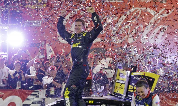 Carl Edwards celebrates in Victory Lane after winning the NASCAR Sprint Cup series auto race at Cha...