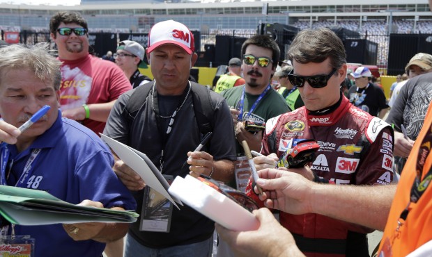 Jeff Gordon signs autographs before practice for Sunday’s NASCAR Coca-Cola 600 Sprint Cup ser...