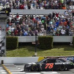 
              Martin Truex Jr. (78) takes the checkered flag to win a NASCAR Sprint Cup Series auto race at Pocono Raceway in Long Pond, Pa., Sunday, June 7, 2015. (AP Photo/Derik Hamilton)
            