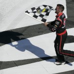 
              Austin Dillon runs across the front stretch with the checkered flag after winning the NASCAR Xfinity series auto race at Charlotte Motor Speedway in Concord, N.C., Saturday, May 23, 2015. (AP Photo/Gerry Broome)
            