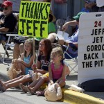 
              Fans sit on the curb as they await the arrival of NASCAR driver Jeff Gordon during parade in his honor in Pittsboro, Ind., Thursday, July 23, 2015. Gordon will drive in Sunday's Brickyard 400.  (AP Photo/Michael Conroy)
            