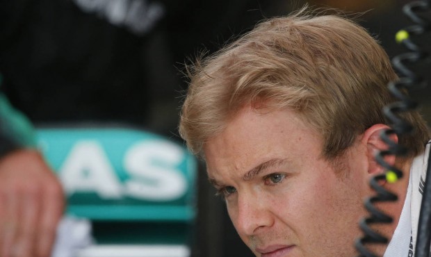 German Mercedes driver Nico Rosberg watches technicians during the first training session for the B...