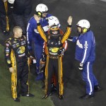 
              Austin Dillon, center, raises his arms to race fans to signify he was okay after he was involved in a multi-car crash in a NASCAR Sprint Cup series auto race at Daytona International Speedway, Monday, July 6, 2015, in Daytona Beach, Fla. (AP Photo/David Graham)
            