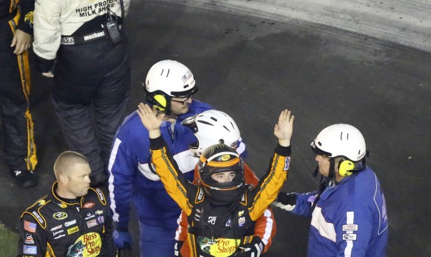 Austin Dillon, center, raises his arms to race fans to signify he was okay after he was involved in...